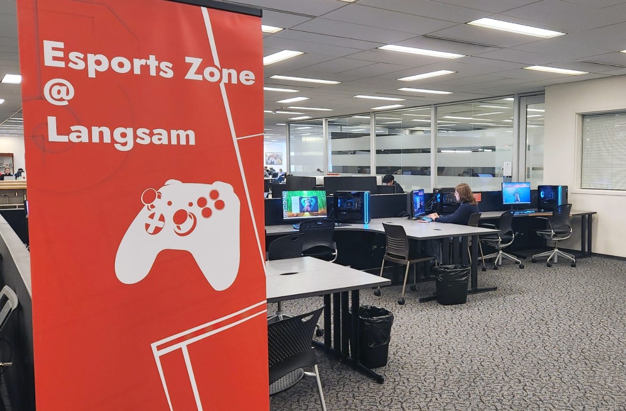 A photograph of the Esports Zone at Langsam Library banner with the gaming computers visible in the background